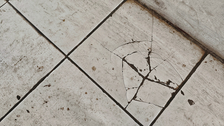 Cracked and dirty white tiling