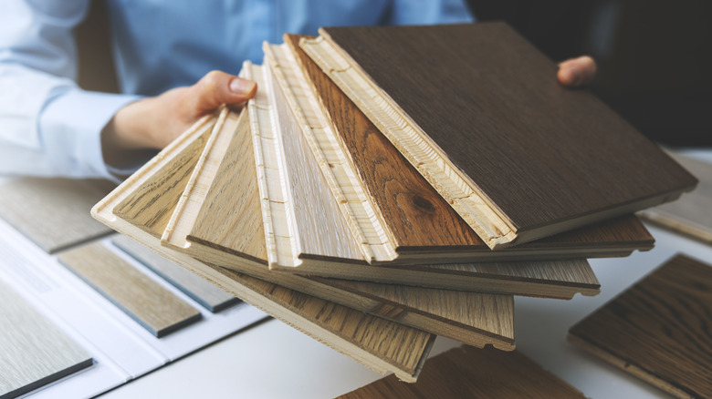 hands holding flooring samples