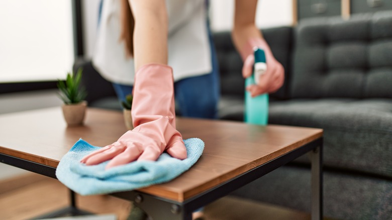 Person wiping down table