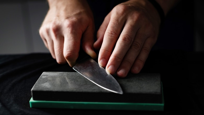 man using a sharpening stone