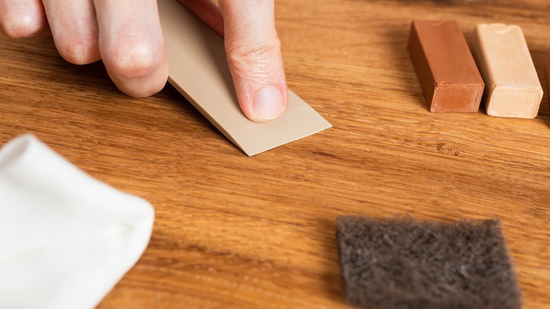 Person repairing wood floor