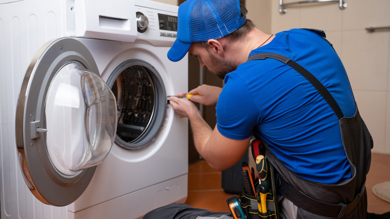 man installing washing machine