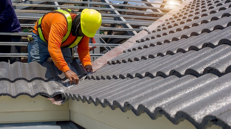 man working on tile roof