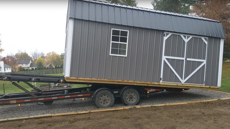 Truck dropping off a pre-assembled shed