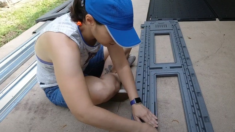 woman assembling a Costco shed