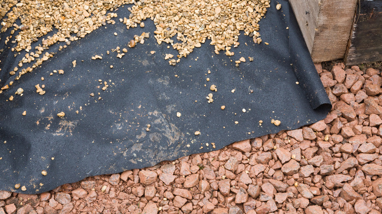 landscaping fabric on looose gravel rocks