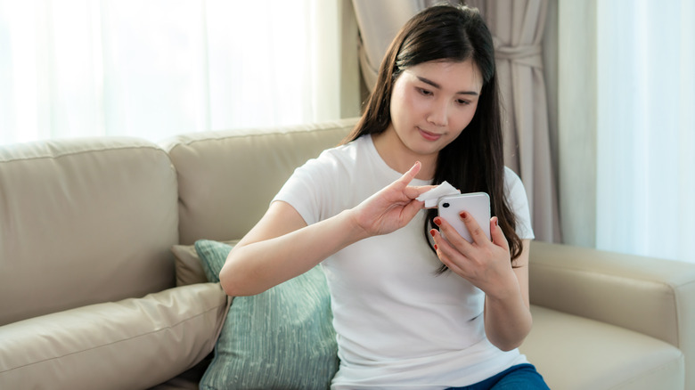 woman cleaning phone