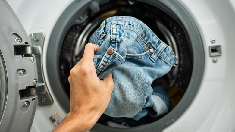 Putting clothes in dryer
