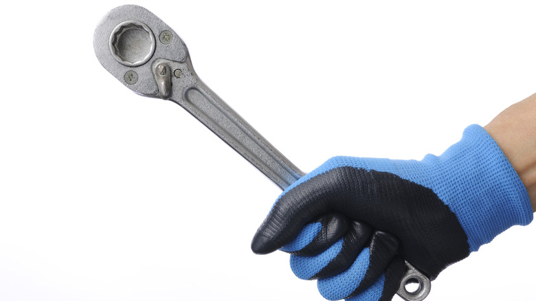 Person holding socket wrench