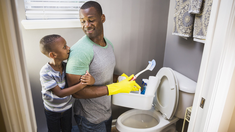 Father and son cleaning toilet