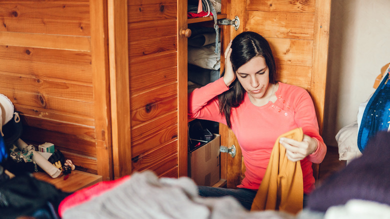 woman organizing clothes closet