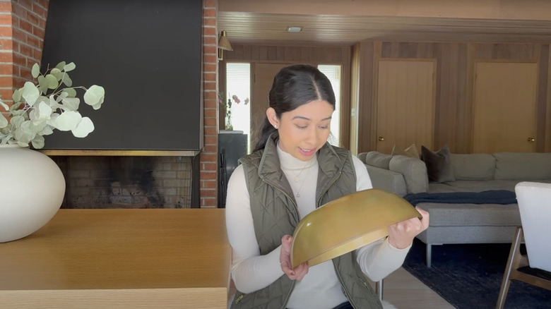 woman examining her garage sale bowl