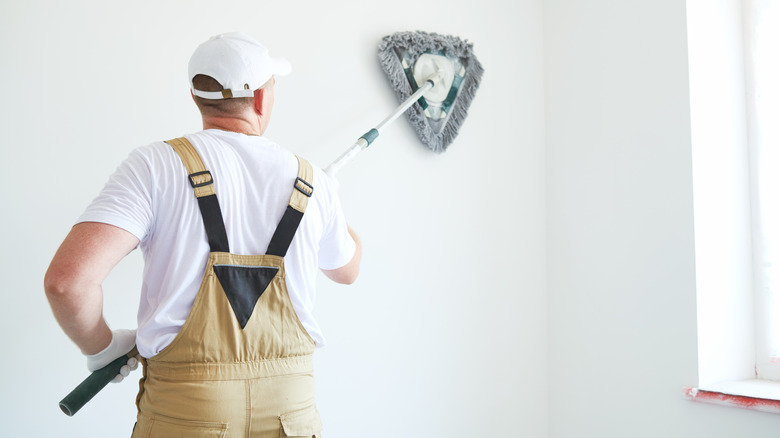 Contractor cleaning wall