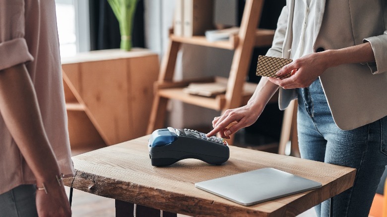 Store clerk processing credit card payment