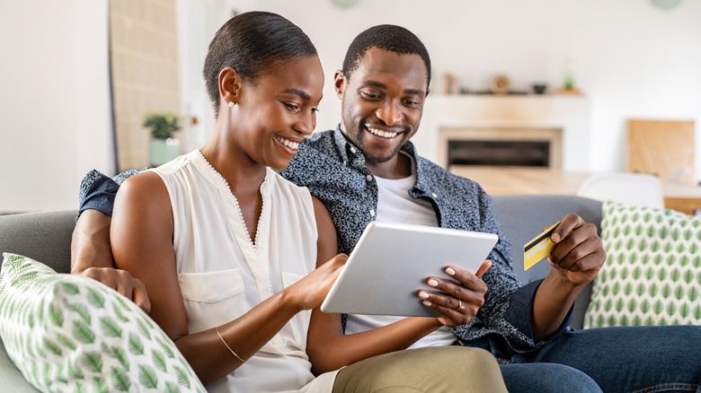 Couple shopping online on tablet