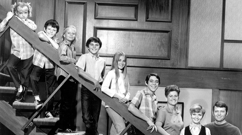 The Brady Bunch family on the stairs