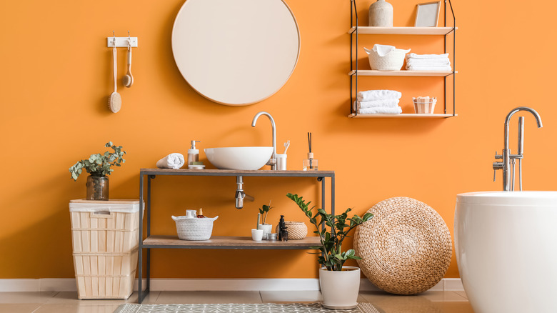 Orange bathroom with white fixtures