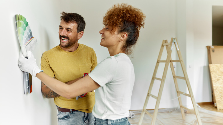 couple browsing paint swatch