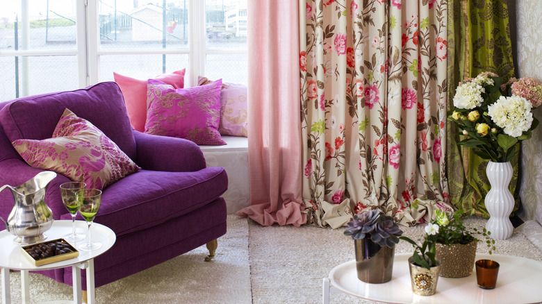 Room with colorful curtains, sofas, and pillows