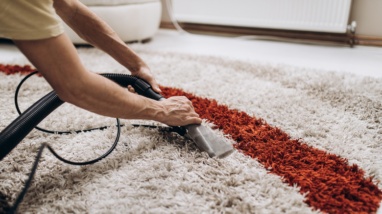 Vacuuming carpet