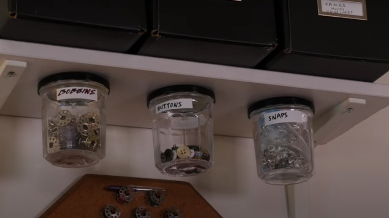 jars mounted under shelf for organization