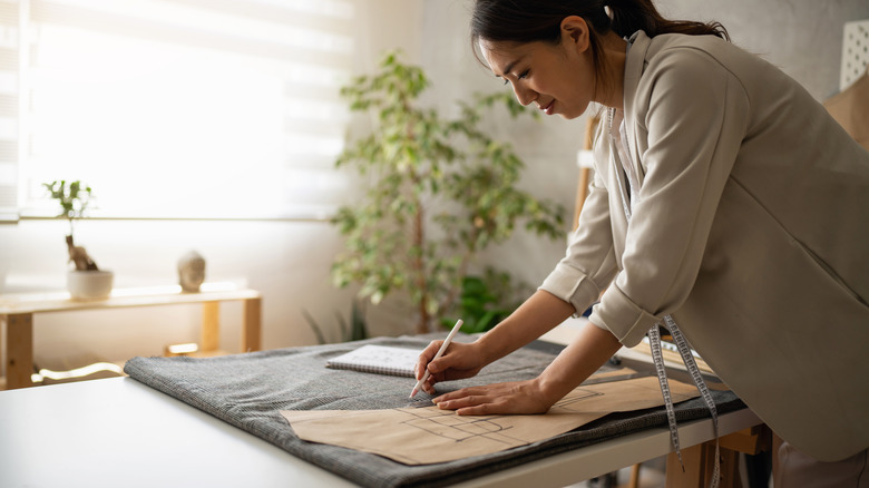 woman sketching on brown paper