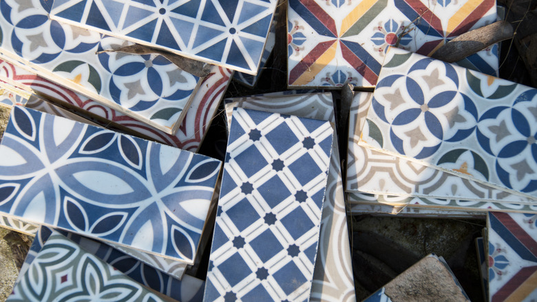 A pile of blue ceramic tile with stylish patterns