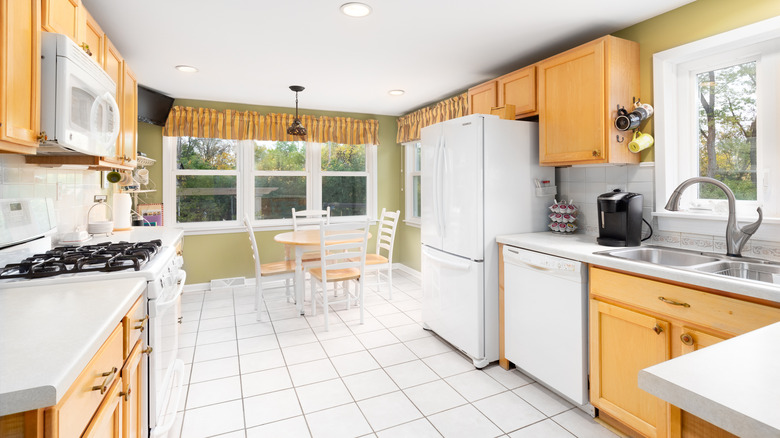 Outdated kitchen with white appliances