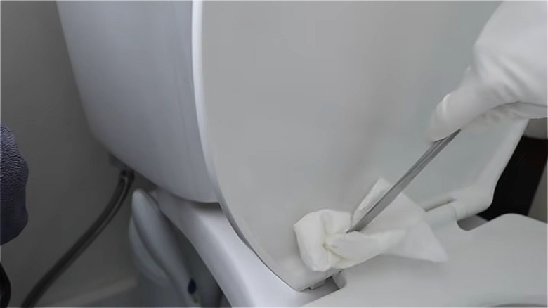 cleaning toilet with butter knife