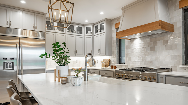 Luxury kitchen with a white marble or quartz countertop