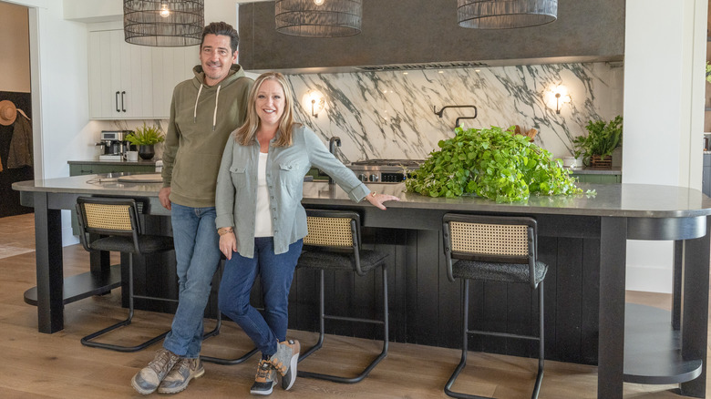 Jonathan Knight and Kristina Crestin smiling in finished kitchen