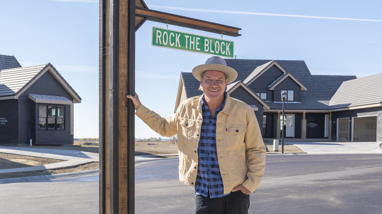 Ty Pennington posing outside the houses