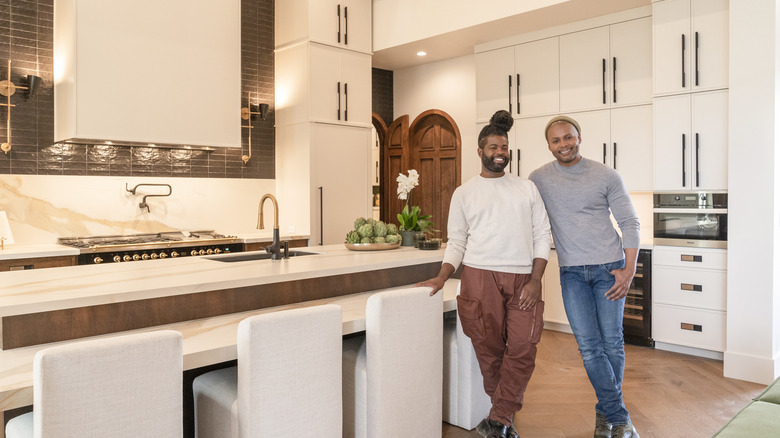 Anthony Elle and Michel Smith Boyd smiling in finished kitchen