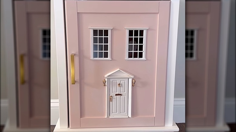 user building dollhouse from nightstand