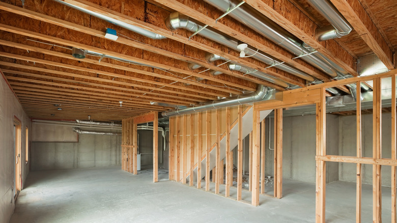 basement ceiling with exposed wiring and ducts