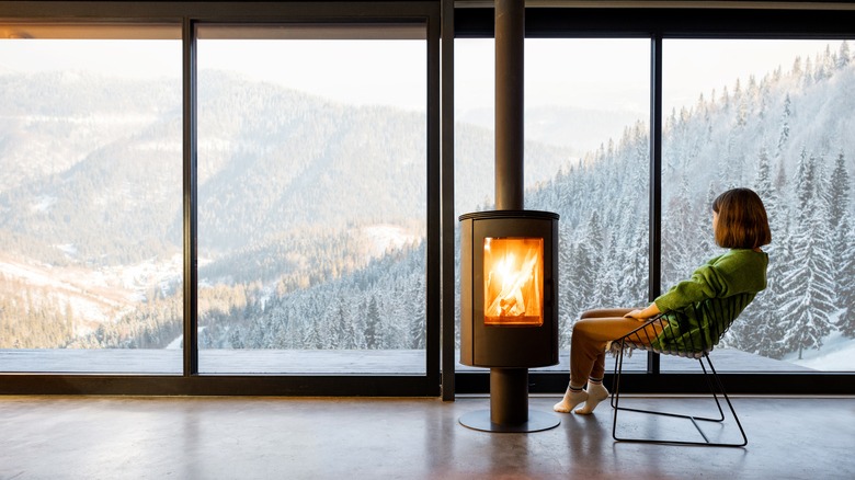 woman next to fireplace