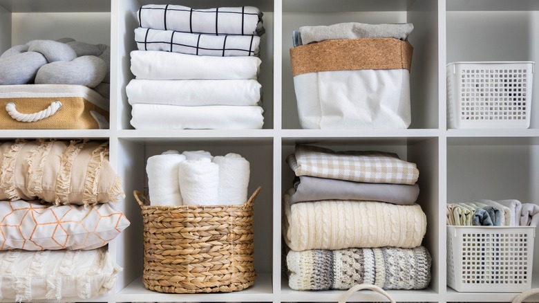 Linen closet with open shelving.