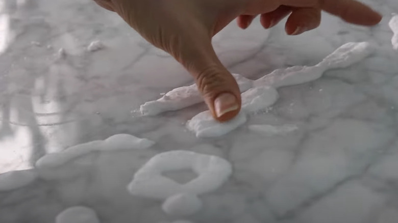 Person rubbing in hydrogen peroxide/baking soda paste