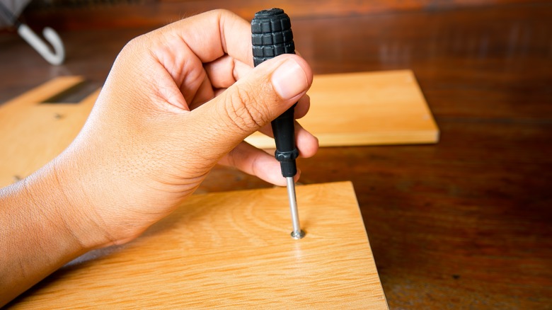 Person using screwdriver