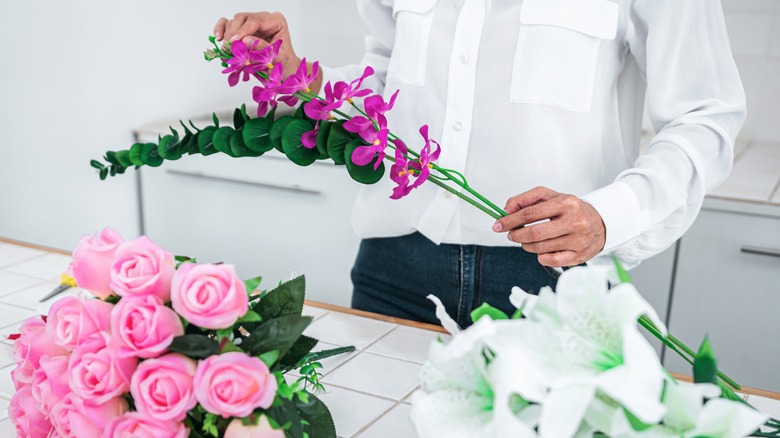 woman holding faux flowers