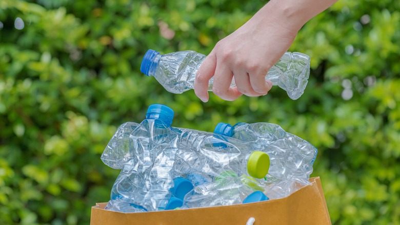 hand grabbing bottle from bag