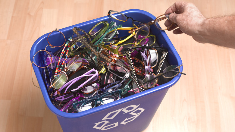 A basket is filled with different pairs of eyeglasses