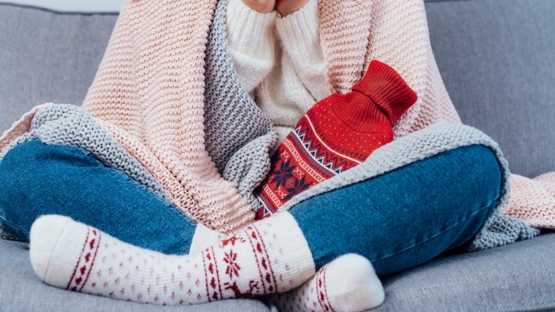 Woman keeping self warm in winter