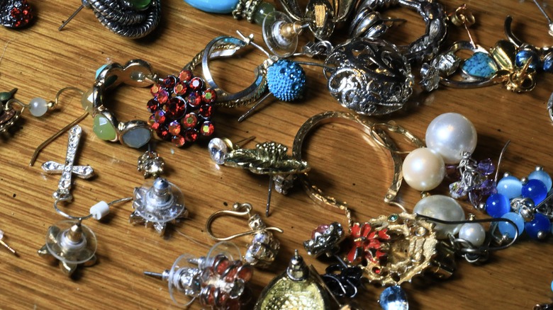 Pile of jewelry on wood surface.