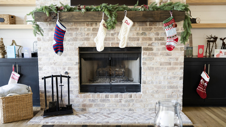 A thin garland on a mantle with other decorations