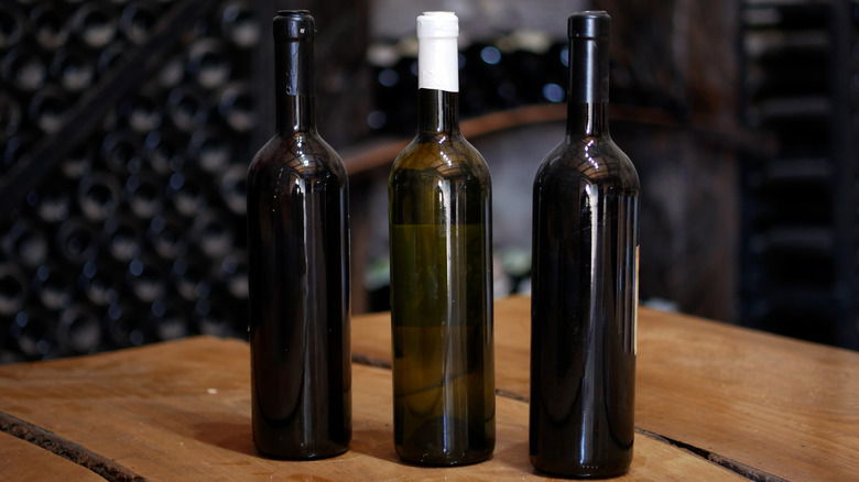 wine bottles with no labels on wooden table