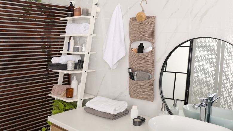 Towel holder with shelves in bathroom