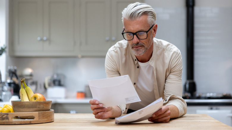 man looking through mail