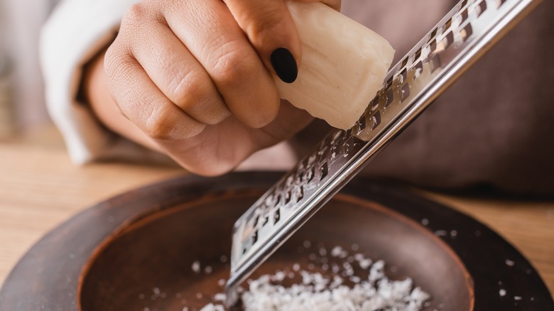 Person grating bar of soap