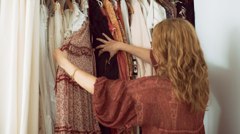 Woman looking through open closet